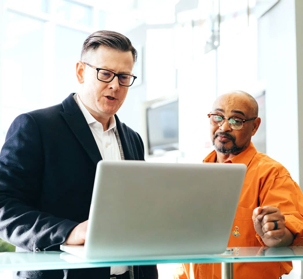 Two men looking at a laptop screen